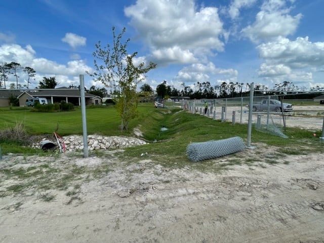 New drainage ditch brings concerns for young children playing in ditch. Area to be fenced in with 6-foot fence and gate