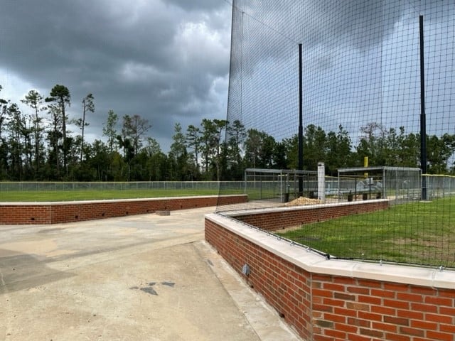 Brick backstops and netting on fields 1 & 2