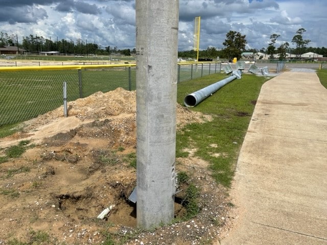 Light poles will be placed over existing cement pole bases with a crane
