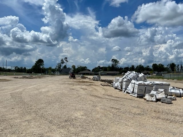 After a year if parking lot full of construction materials, area is almost clear