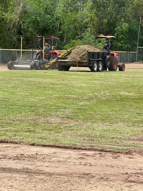 Clearing the top layer of sod off of Field 11